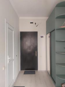 a hallway with a black door in a room at Batumi in Itʼkhvisi