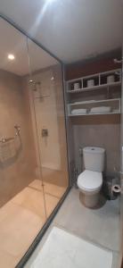 a bathroom with a toilet and a glass shower at Recife Infinity Pool - VIP in Recife
