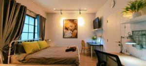 a bedroom with a bed and a desk and a window at Asia Boutique Club Residence 1 in Pathum Thani +69 photos