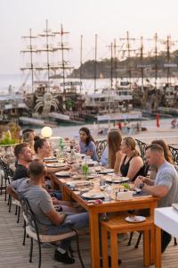 a group of people sitting at tables at a restaurant at Jade Residence in Oludeniz +51 photos