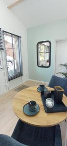 a wooden table with plates and bowls on it in a room at Entre ciel et Sèvre in Treize-Vents +21 photos