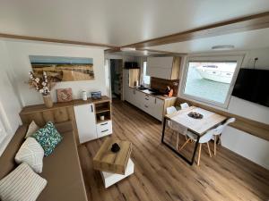 a small living room with a couch and a table at SeaEsta Floating Houses in Constanţa