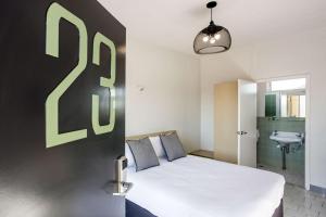 una camera da letto con un letto con una grande lettera b sul muro di Nightcap at Emerald Star Hotel a Emerald