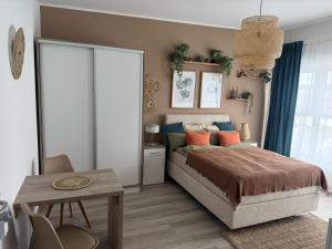a bedroom with a large bed and a table at Appartement's in Mayen in Mayen +17 photos