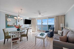 a living room with a couch and a table at Pelican Beach Resort Top 20th Floor Condos with Ocean View in Destin