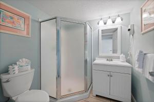 a bathroom with a shower and a toilet and a sink at Pelican Beach Resort Top 20th Floor Condos with Ocean View in Destin