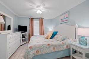a bedroom with a bed and a ceiling fan at Pelican Beach Resort Top 20th Floor Condos with Ocean View in Destin