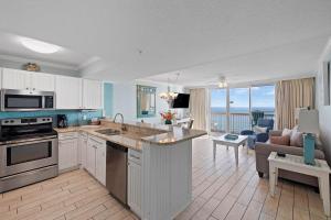 a kitchen and living room with a view of the ocean at Pelican Beach Resort Top 20th Floor Condos with Ocean View in Destin +27 photos
