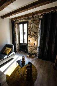 a living room with a couch and a table at "Un Lieu Unique" le Gold et le Cocon in Annecy