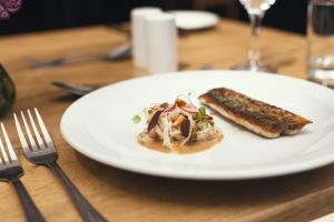 a white plate with a piece of food on a table at Stoke Lodge Hotel in Stoke Fleming
