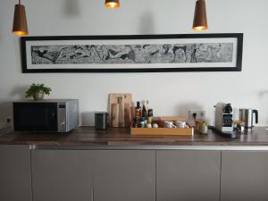 a kitchen with a counter with a microwave and a table at Bacán in The Hague