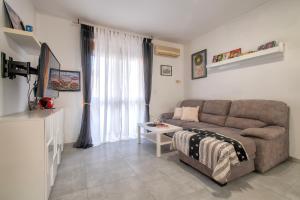 a living room with a couch and a table at L'Angolo di Anna - Alghero, Italy in Alghero