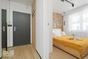 een slaapkamer met een bed en een groot raam bij Zielona 16 D&D Apartments in Międzywodzie