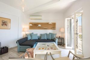 a living room with a couch and a table at Seaside Bliss 3, Ganema Serifos in Ganema