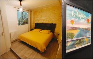 a bedroom with a yellow bed and a painting at Le Logis, Villa Beaulieu in Saumur