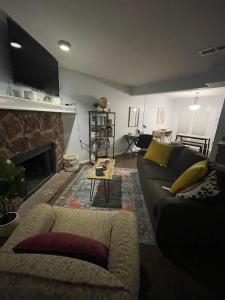 a living room with a couch and a fireplace at Cozy 2BR 2BA apt close to Siegen & Womans in Baton Rouge