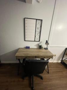 a table in a room with a desk with a chair at Cozy 2BR 2BA apt close to Siegen & Womans in Baton Rouge