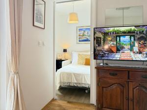 a bedroom with a bed and a flat screen tv at Viola Apartment in Poreč