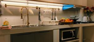 a kitchen counter with a sink and a bowl of fruit at Asia Boutique Club Residence 1 in Pathum Thani