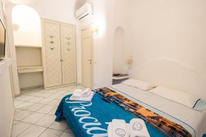 a bedroom with a bed with towels on it at La Dolce Vita By Fantasy in Forio d'Ischia