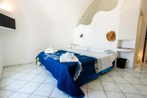 a bedroom with a bed with towels on it at La Dolce Vita By Fantasy in Forio d'Ischia +28 photos