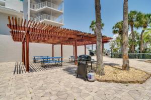 a picnic shelter with two benches and a trash can at Condo Across From Clearwater Beach Boardwalk in Clearwater Beach