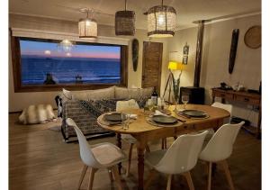 a dining room table and chairs with a view of the ocean at Frente al Mar - Punta de Choros Casa La Changa in La Higuera