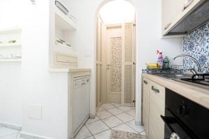 a kitchen with a sink and a counter top at La Dolce Vita By Fantasy in Forio d'Ischia