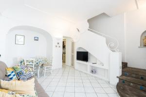 a living room with a couch and a tv at La Dolce Vita By Fantasy in Forio d'Ischia