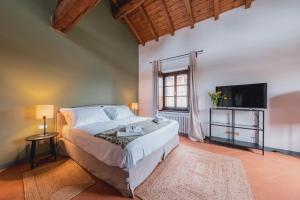 Postel nebo postele na pokoji v ubytování Relais Macconago