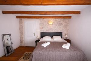 ein Schlafzimmer mit einem großen Bett und weißen Kissen in der Unterkunft Hello Sunshine in Veli Iž