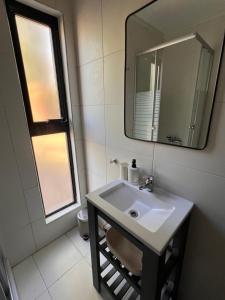 a bathroom with a sink and a mirror at La Misión Tiny Houses in Ciudad Lujan de Cuyo +21 photos