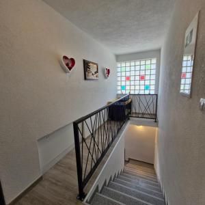 a hallway with a staircase with hearts on the wall at Vila Natasa Apartment 4 near Plitvice in Vrhovine