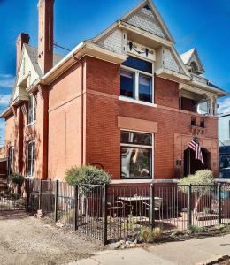 a brick house with a fence in front of it at Off Broadway B & B in Denver +58 photos