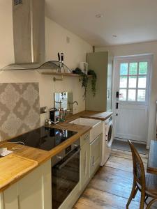 a kitchen with a sink and a dishwasher at Cottage of Content in Wivenhoe +14 photos