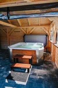 a large wooden room with a large tub in it at Wczasy u Juliana in Drewnica