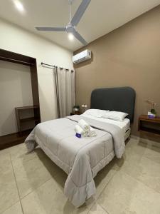 a bedroom with a bed with towels on it at Hotel and Suites Hortensias in Tapachula