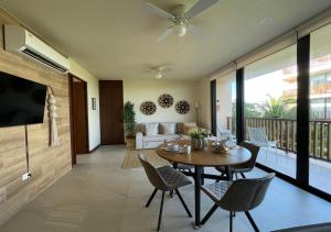 a living room with a table and chairs at Sunset 2BR Apartment Steps from the Beach with Ocean View in Holbox Island