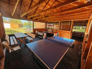 a ping pong table in the middle of a room at Wczasy u Juliana in Drewnica +5 photos