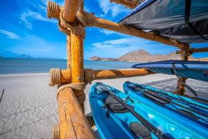 a blue kayak sitting on the beach at Stylish Summer 2BR Retreat w Pool & Beach Access in Ensenada Blanca