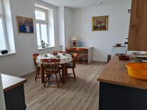a kitchen and dining room with a table and chairs at Gambrinus Schneeberg in Schneeberg