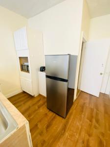 a stainless steel refrigerator in a kitchen with wooden floors at One bedroom near Whole Foods, Brown Univeristy, Miriam Hospital 531 in Providence
