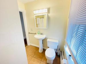 a bathroom with a white toilet and a sink at One bedroom near Whole Foods, Brown Univeristy, Miriam Hospital 531 in Providence