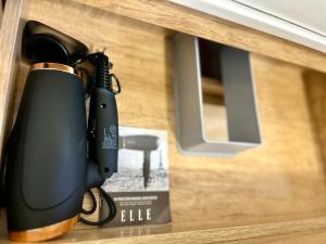 a flashlight in a wooden drawer next to a box at Appartement Cosy La Vanille 1 in Ducos +13 photos