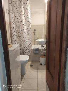 a bathroom with a toilet and a sink at Chora's Stonehouse in Andros