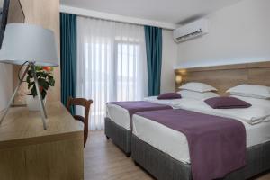 Postel nebo postele na pokoji v ubytování Hotel Porat