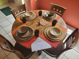 a wooden table with plates and hats on it at King's Cave! in San Juan