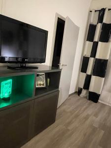 a living room with a flat screen tv on a dresser at 36 Nürburgring in Mayen in Mayen