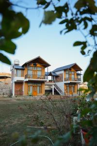 a building with orange doors and balconies on it at Ethnic Trail Homestay in Bhīm Tāl