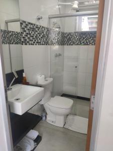 a bathroom with a toilet and a sink and a shower at Conexão Mineira in Pedro Leopoldo +6 photos
